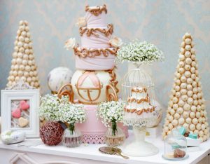 Elegant sweet table with big cake and macaroon on dinner or event party
